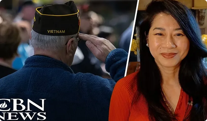 A Vietnam veteran saluting beside a CBN News interview